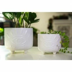 Flora Bunda 6 in. and 4.75 in. Matte White Evil Eye Ceramic Plant Pot with Legs (Set of 2) -US Flora Bunda Sales 2022 matte white flora bunda plant pots ct1423e2 mtwh 76 1000